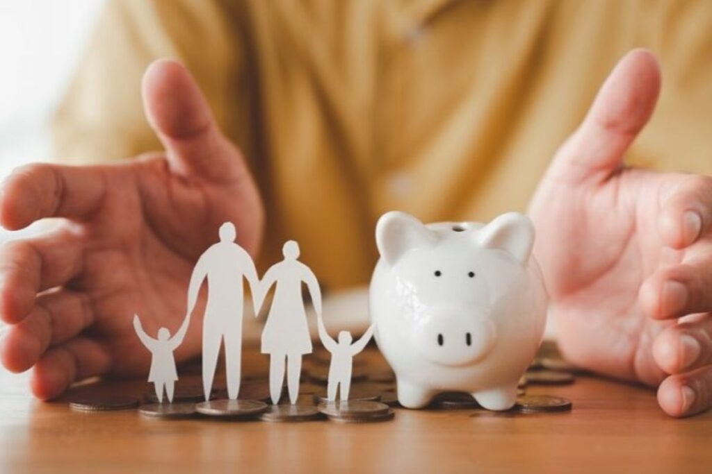 A piggy bank and a paper-cut family