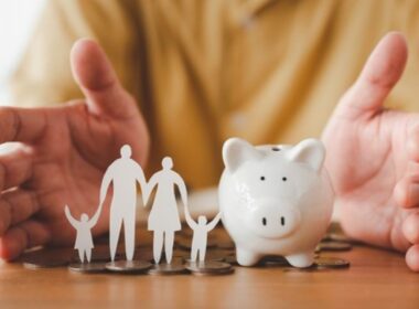 A piggy bank and a paper-cut family