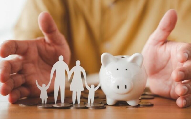 A piggy bank and a paper-cut family