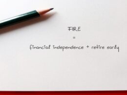 a pen on a piece of paper that says FIRE - financial independence + retire early