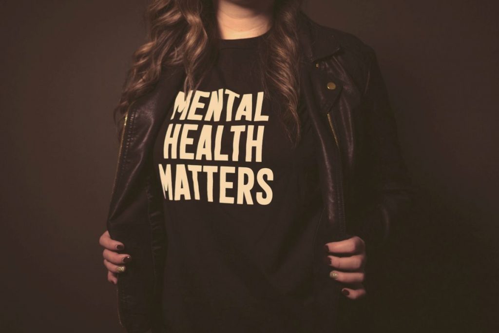 A torso wearing a T-shirt with Mental Health Matters on the front
