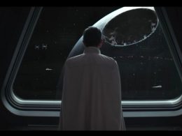 A figure looks out of a spaceship window onto the Death Star
