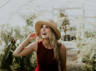 A smiling woman in a jaunty hat