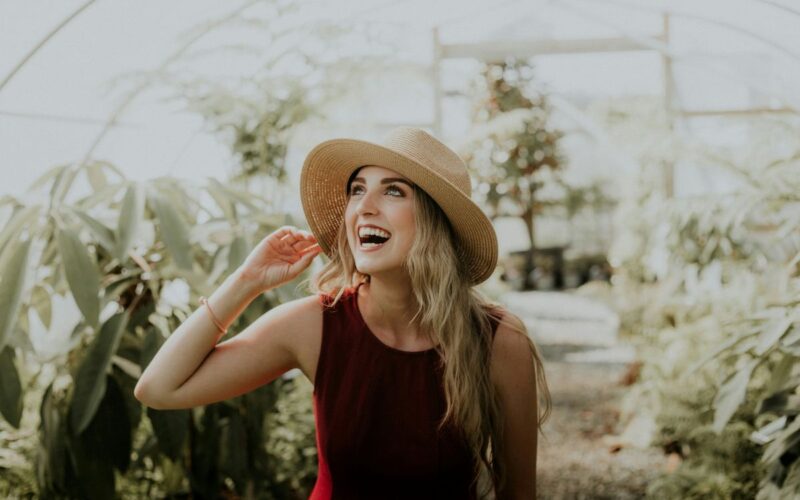 A smiling woman in a jaunty hat