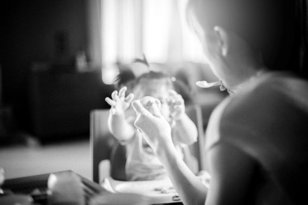A woman feeding a baby