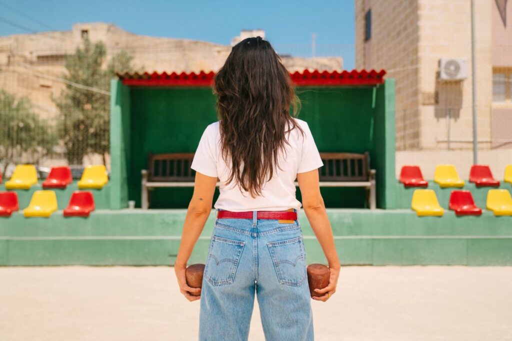 A woman playing boċċi