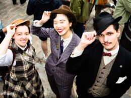 Three smart people tip their hats