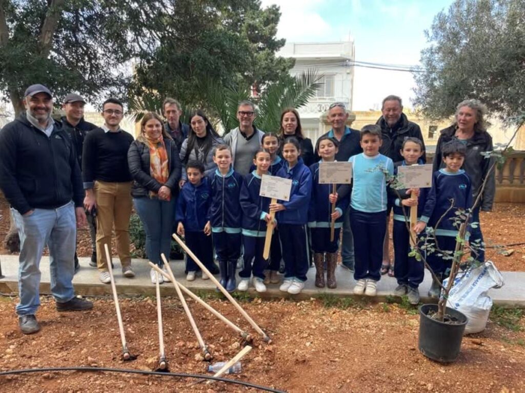 Teachers and students with gardening tools