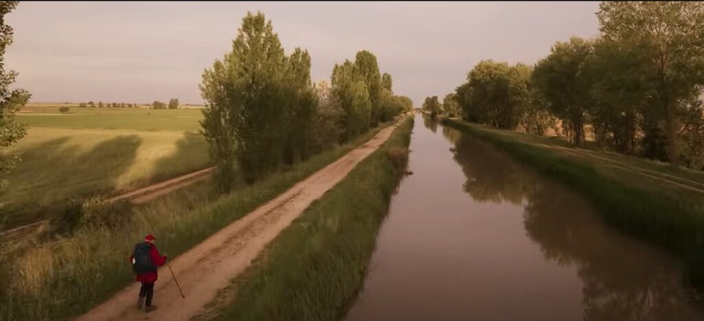 A long empty path by a canal