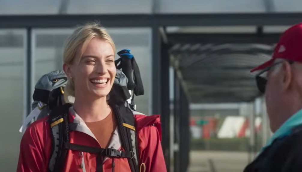 A smiling woman dressed to walk