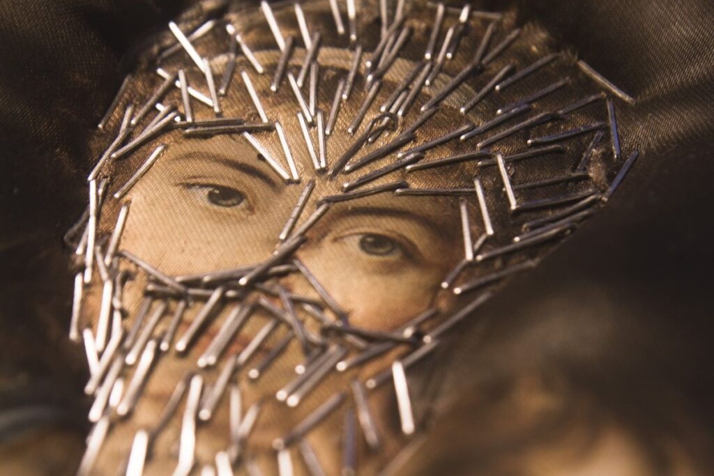 A woman's face with stapled 'veil'