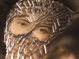 A woman's face with stapled 'veil'