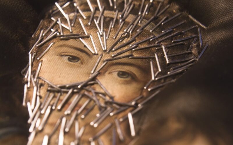 A woman's face with stapled 'veil'