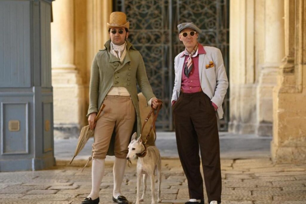 Two men in historical costumes and a dog