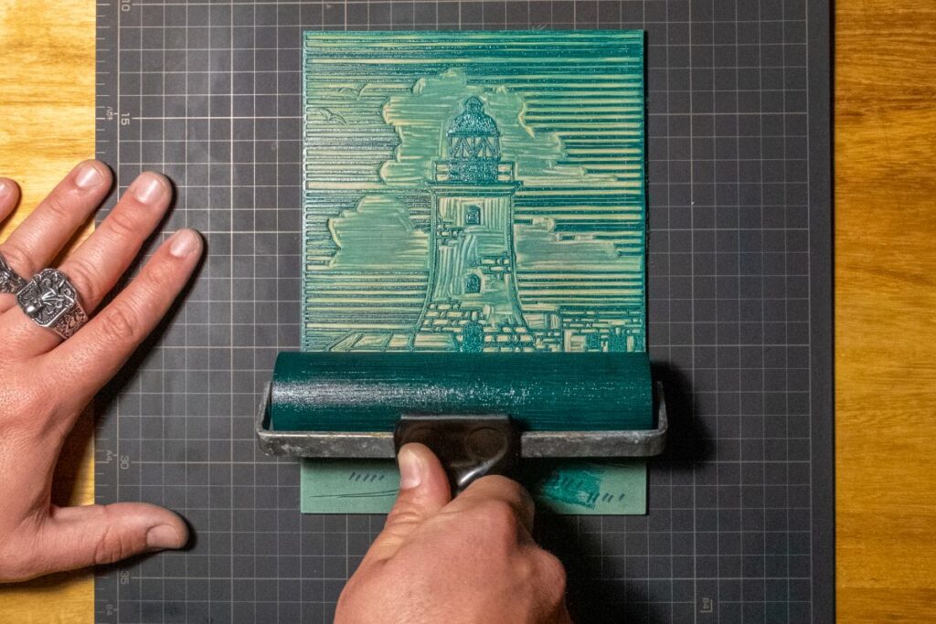 A roller inking a lino