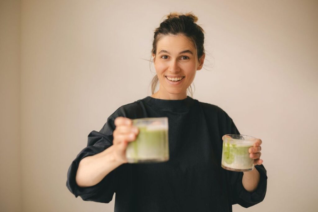 A woman with two glasses of matcha