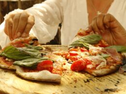 a woman's hands serving pizza