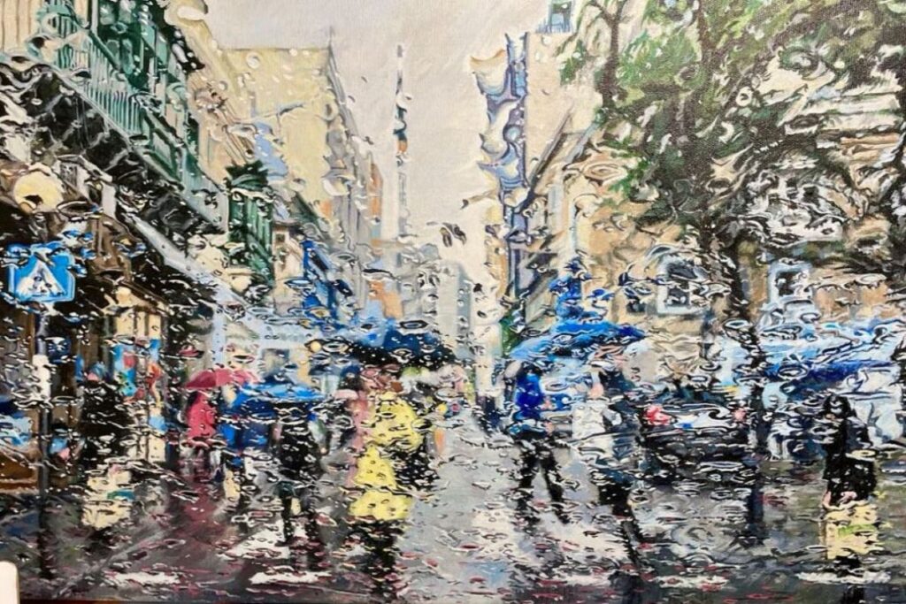 A Maltese streetscene in the rain, seen through a wet windscreen