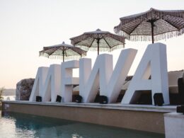 A giant MFWA 2025 logo by a pool