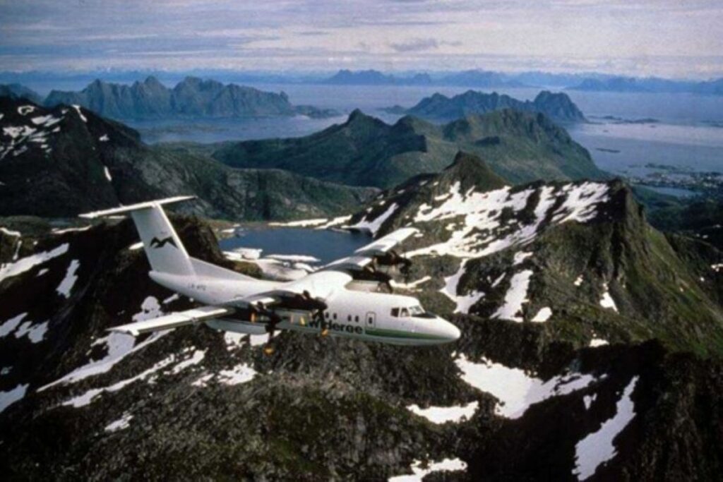 The Dash 7 in flight over mountains
