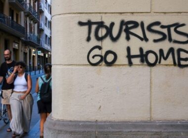 An image of graffitti in Barcelona saying Tourists Go Home