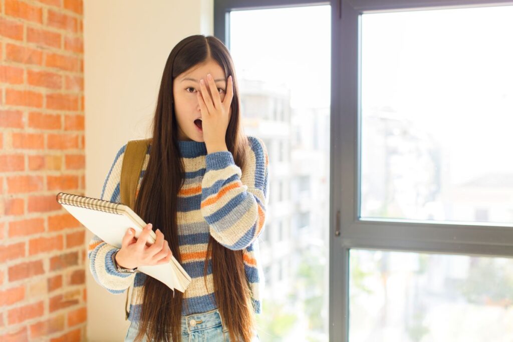 A young woman looking embarrassed