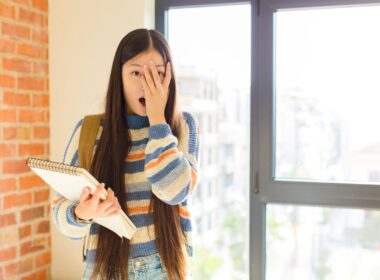 A young woman looking embarrassed