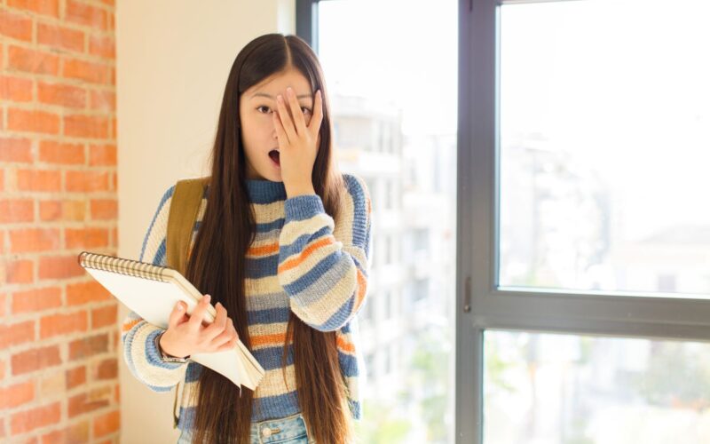 A young woman looking embarrassed