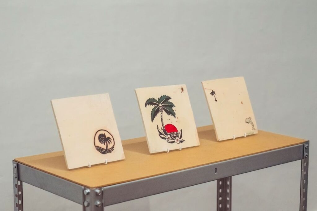 Three ceramic tiles decorated with Mediterranean island imagery