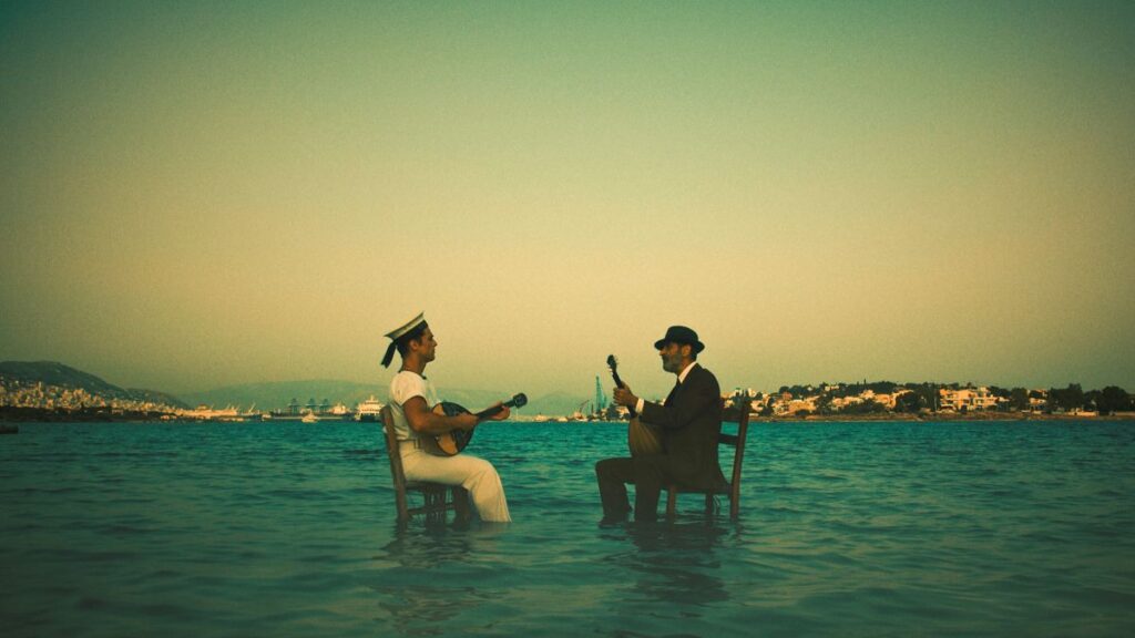 Two men on chairs sitting in the sea