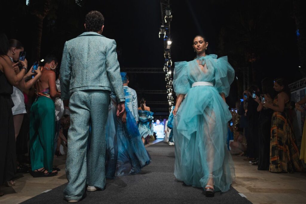 Models wearing outfits from the latest Charles and Ron collection.