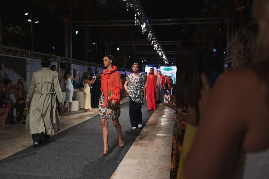 Models wearing outfits from the latest Charles and Ron collection.