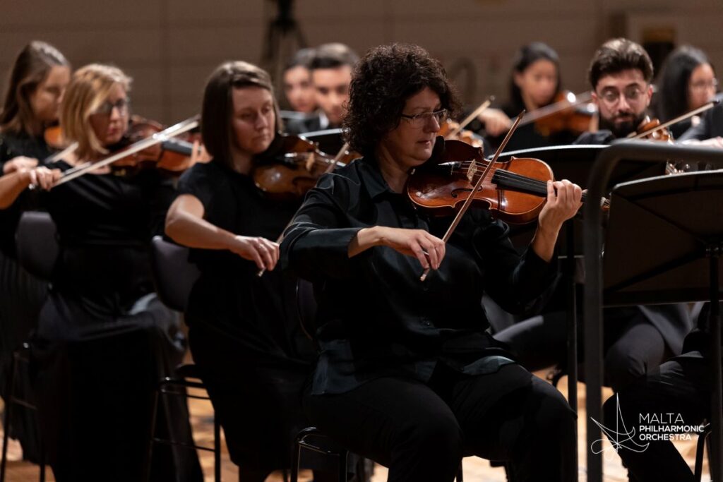 MPO leader Marcelline Agius playing in the orchestra