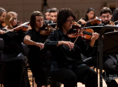 MPO leader Marcelline Agius playing in the orchestra