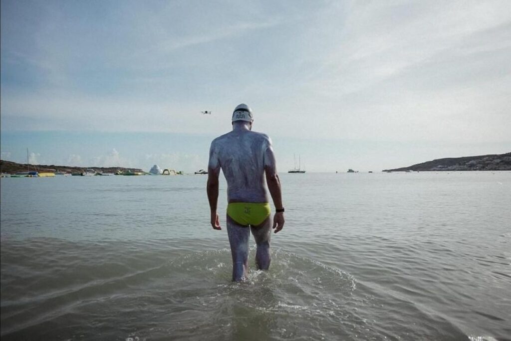Neil Agius walks into the sea