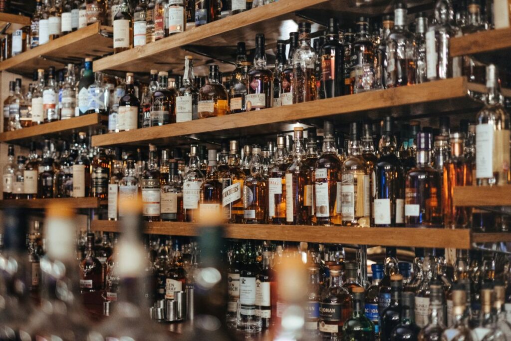 Many bottles of spirits behind a bar