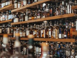 Many bottles of spirits behind a bar