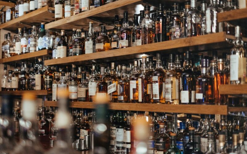 Many bottles of spirits behind a bar