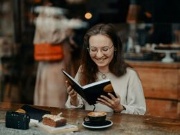 A woman laughing at a book