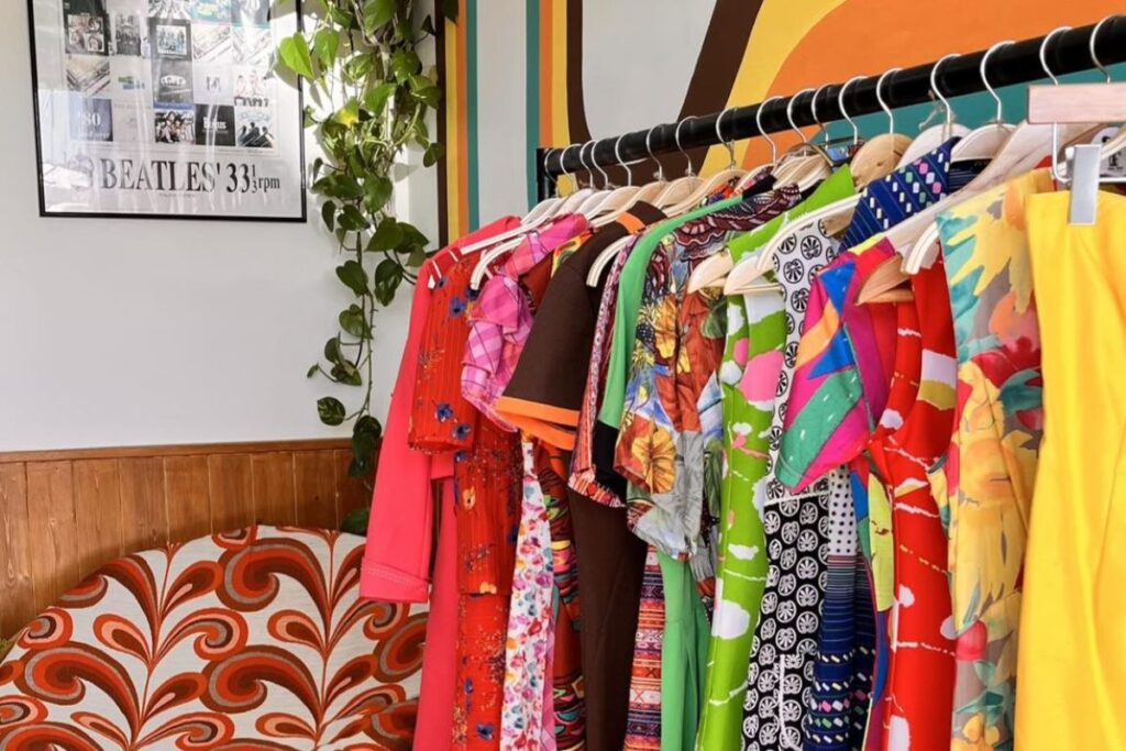 Brightly coloured garments on a rail