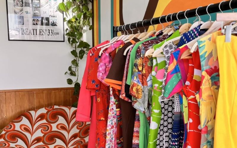 Brightly coloured garments on a rail