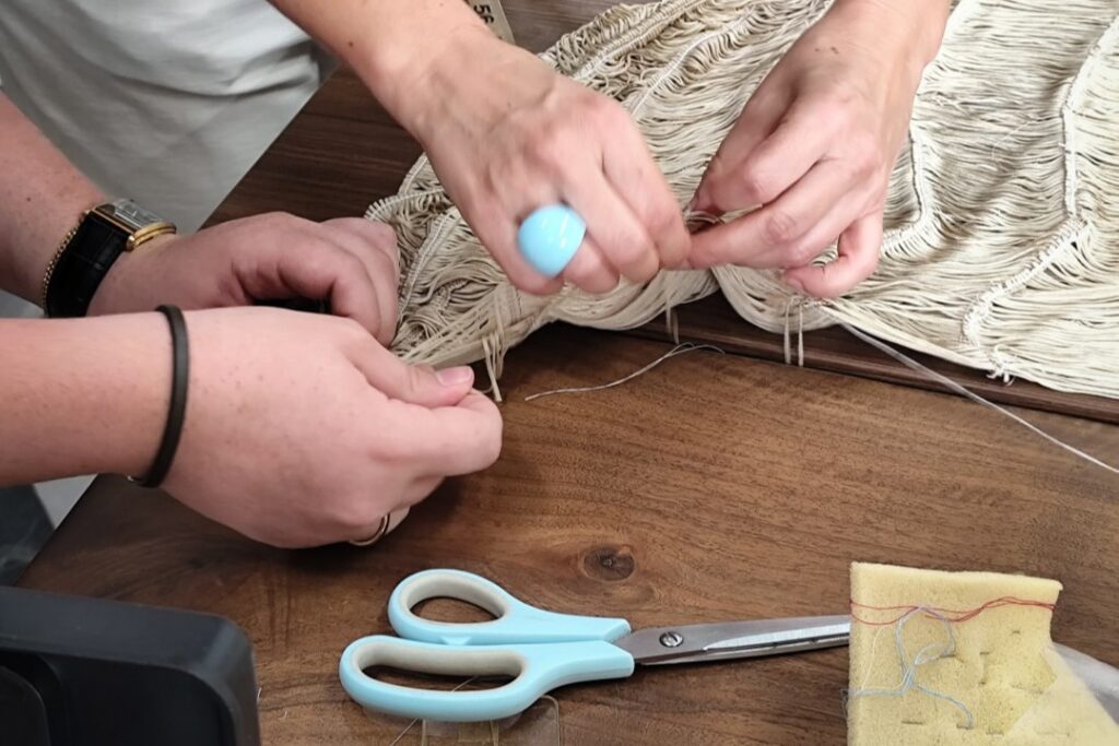 Scissors, fabric and hands