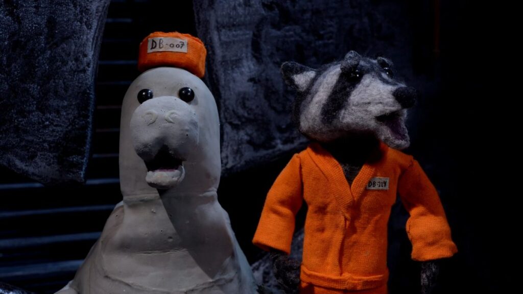 Two animals in prison scrubs