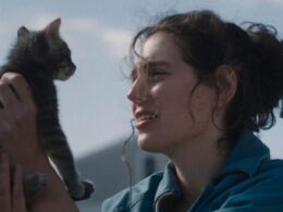 A woman holds a cat up to her face