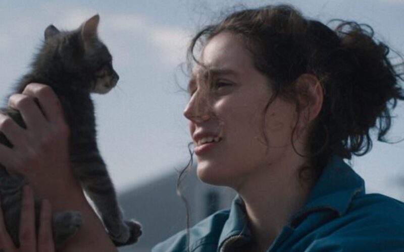 A woman holds a cat up to her face