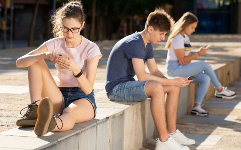 Teenagers on their phones