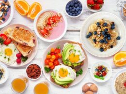 Many plates of healthy-looking food in bright colours
