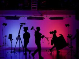 Silouettes of people beahind the scenes on a stage set
