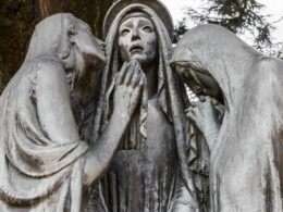 A sculpture of the three Marys at the foot of the cross of Christ