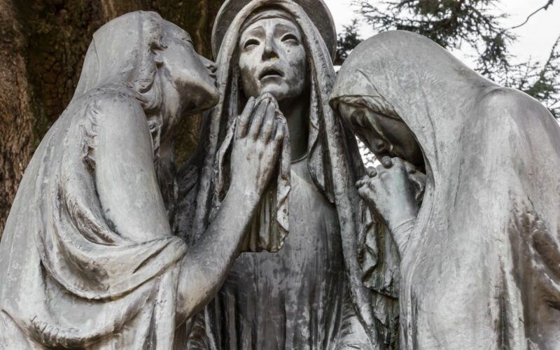 A sculpture of the three Marys at the foot of the cross of Christ